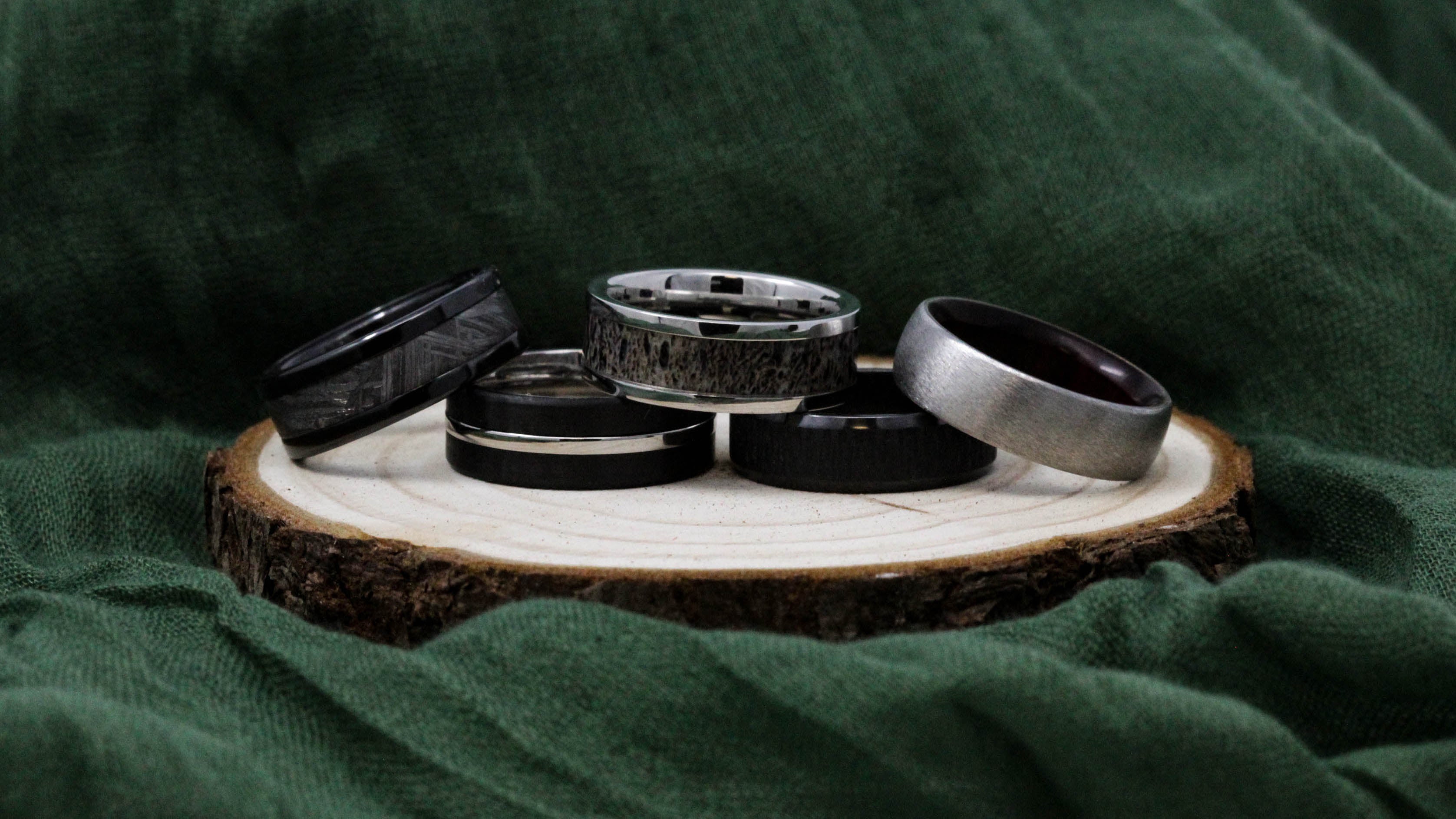 Black zirconium and cobalt chrome wedding bands with antler, meteorite, wood and sterling silver inlays.