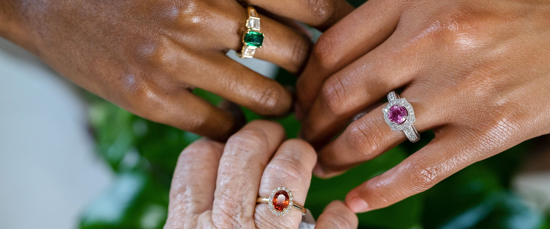 colored gemstone rings on hands