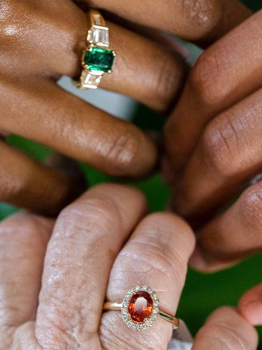 colored gemstone rings on hands